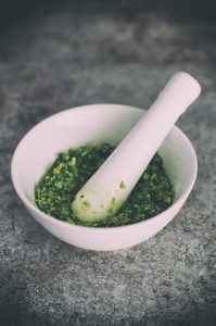 mortar and pestle with greens